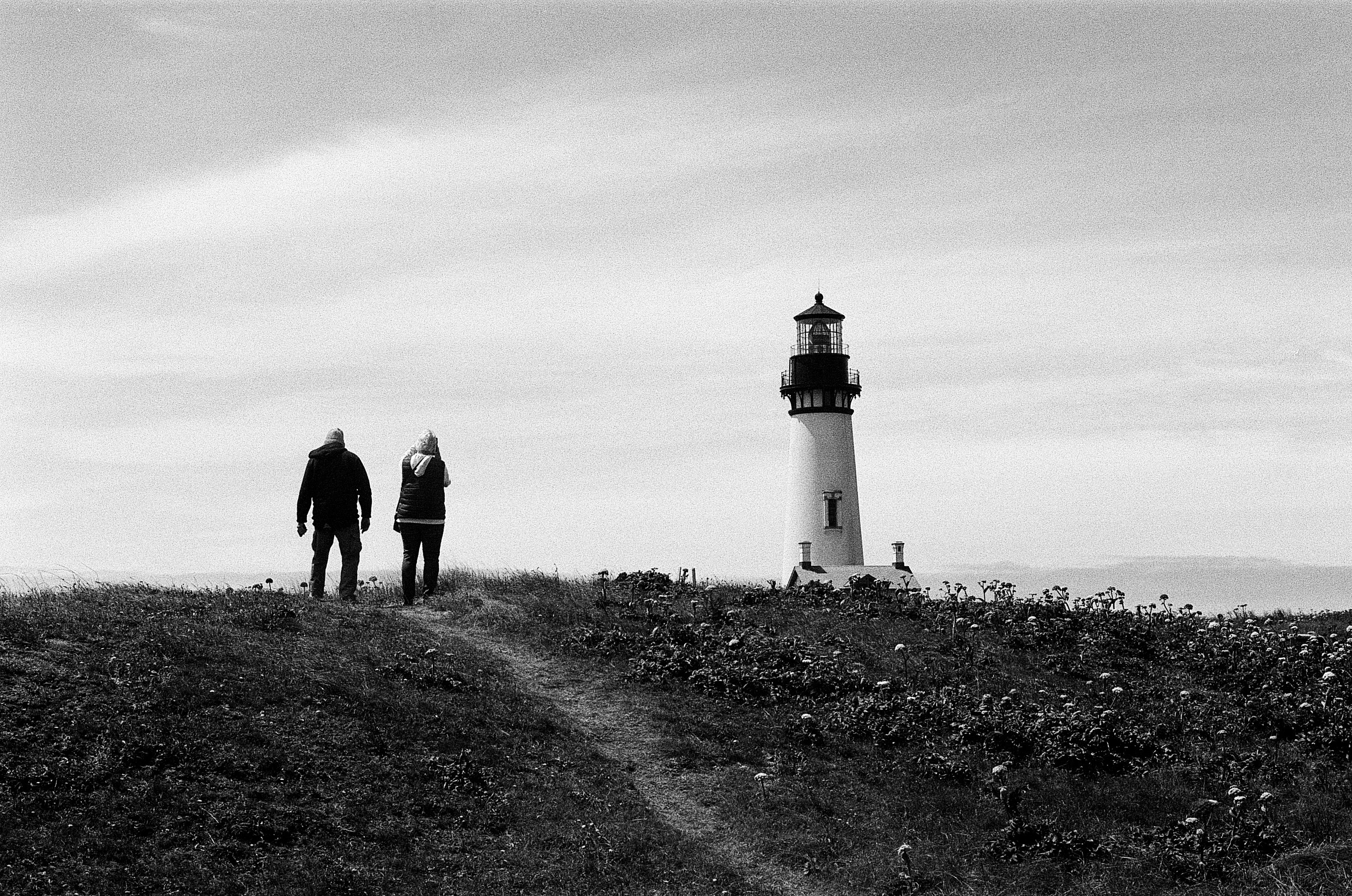Two figures by lighthouse