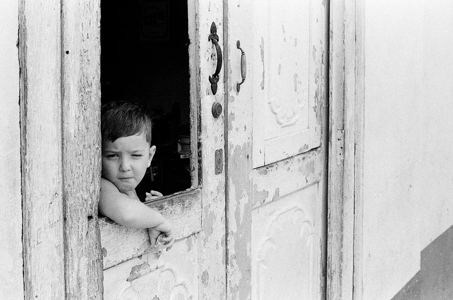 Winking kid in door cuba